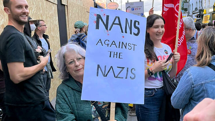 Elderly woman holding anti-fascist sign in Walthamstow, East London.