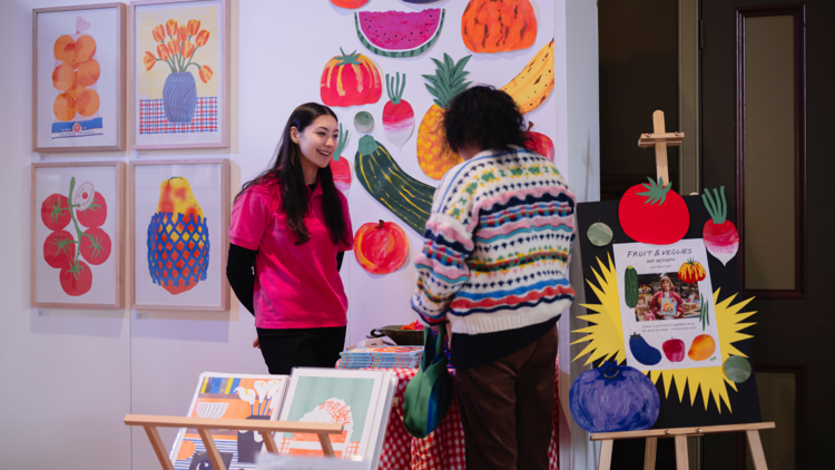 Customer talks to a stall holder at the affordable art fair