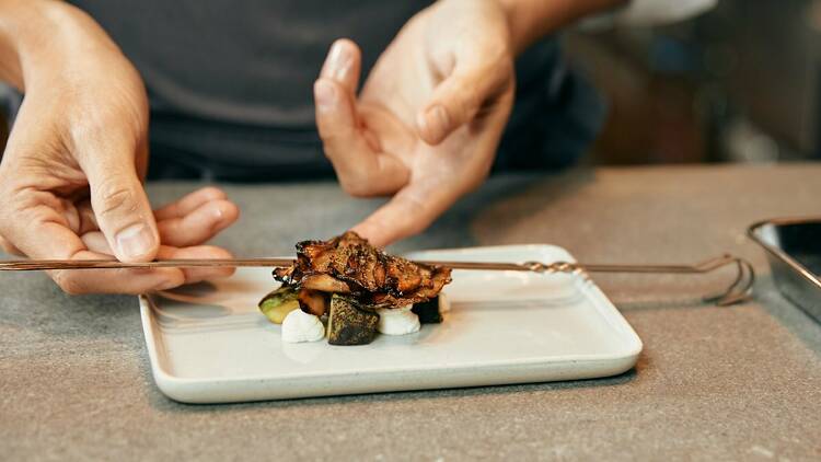 Chef Stephen Gillanders plates a dish at Time Out Market Chicago. 