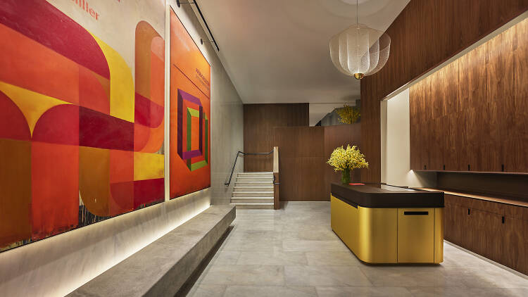 Lobby of Modernhaus SoHo with two large portraits from Harland Miller