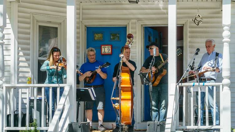 musicians performing on a porch