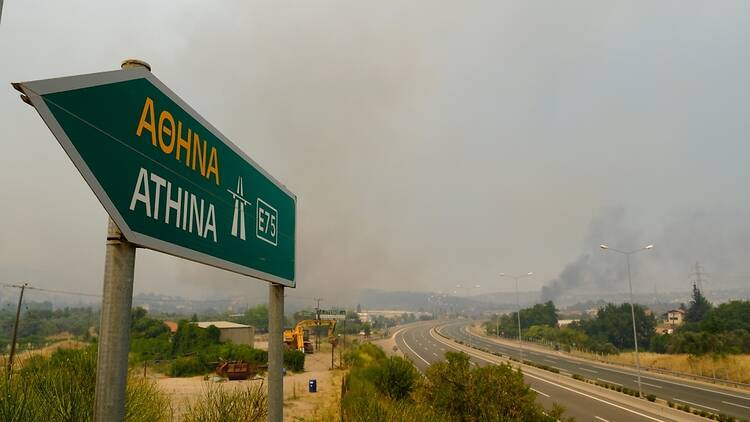 Athens sign with smoke in background