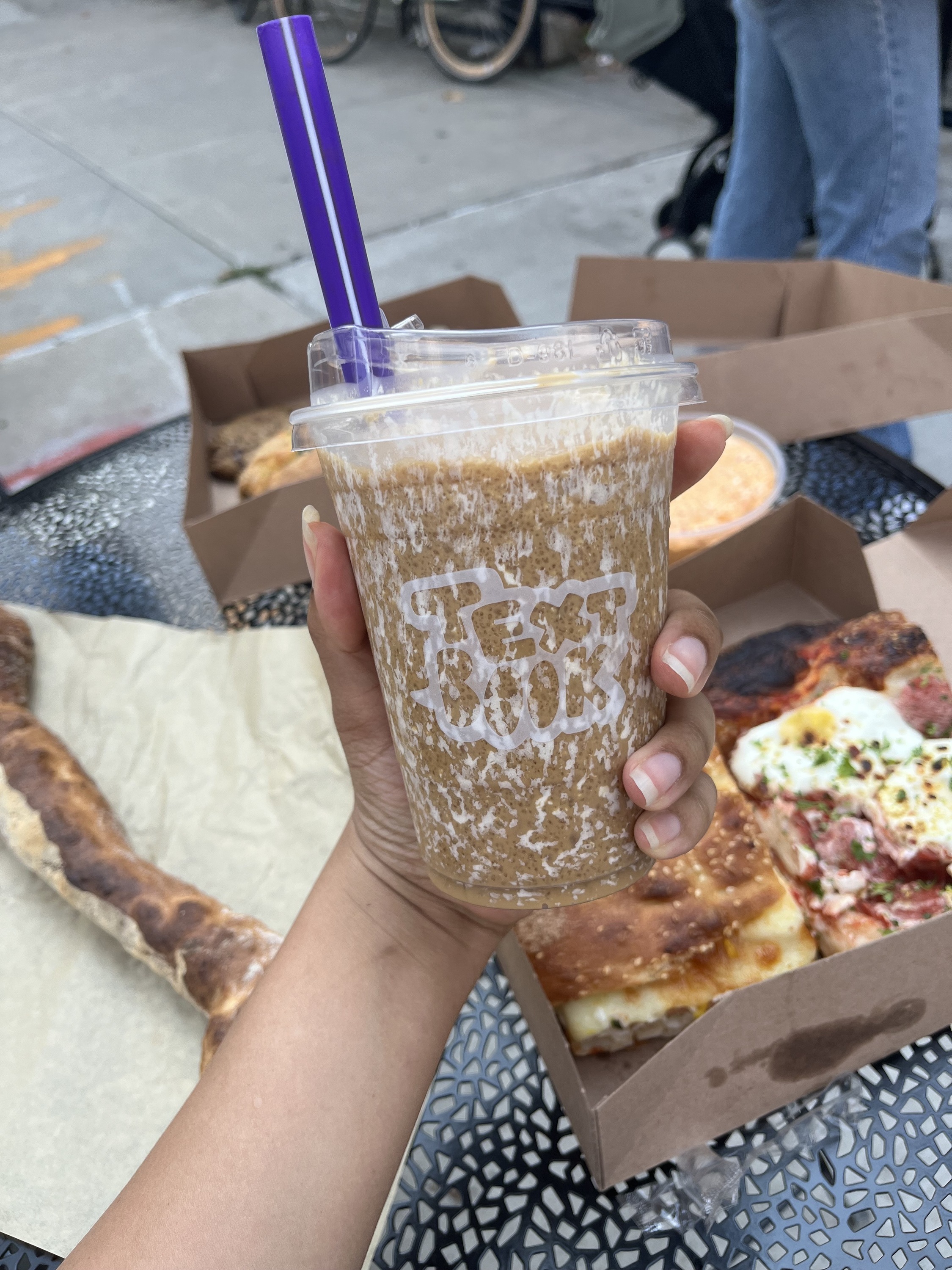 A hand holds a tahini Cold Brew 