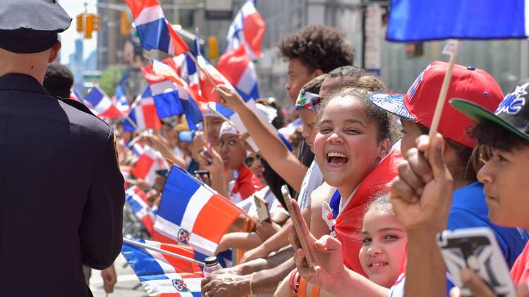 People cheer with Dominican flags