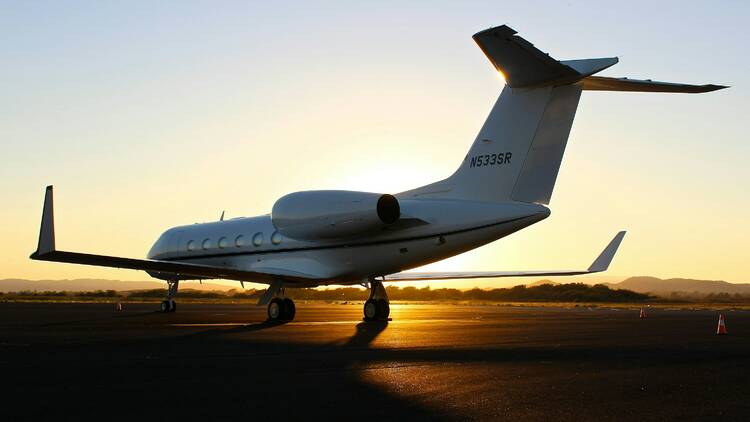 Airplane on runway at sunset