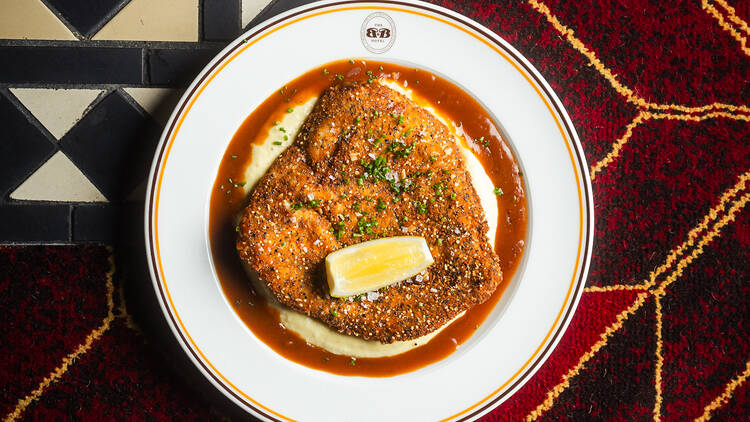 Chicken schnitzel on a table.