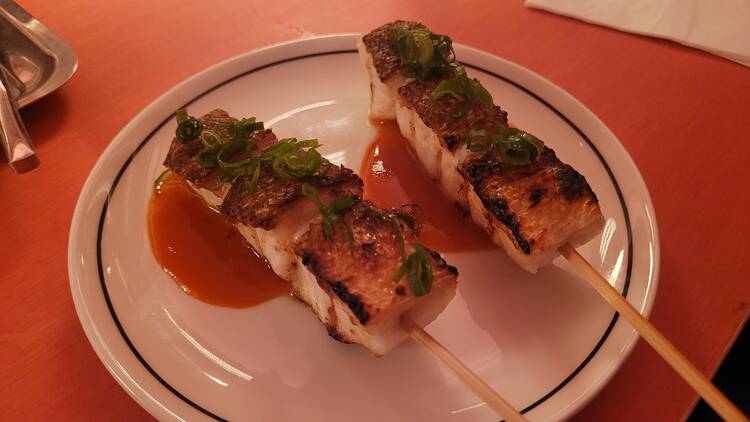 Two fish skewers on a plate