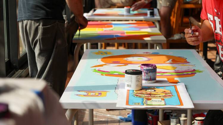 Tables being painted by artists