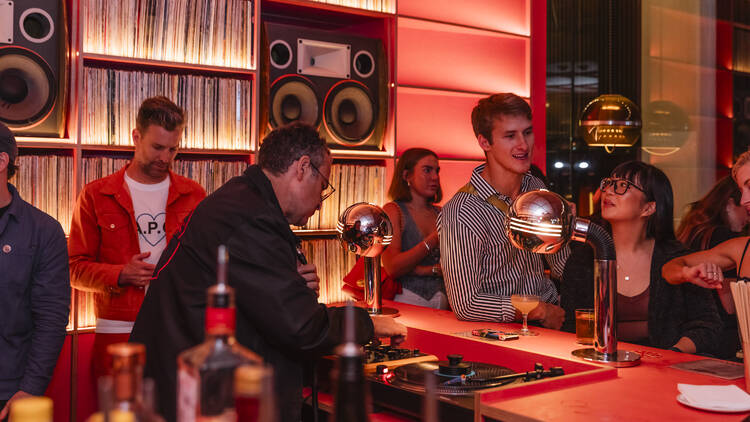 A record bar with a DJ spinning vinyl.