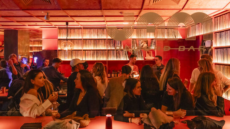 A pink-hued bar with the words JAM on the window