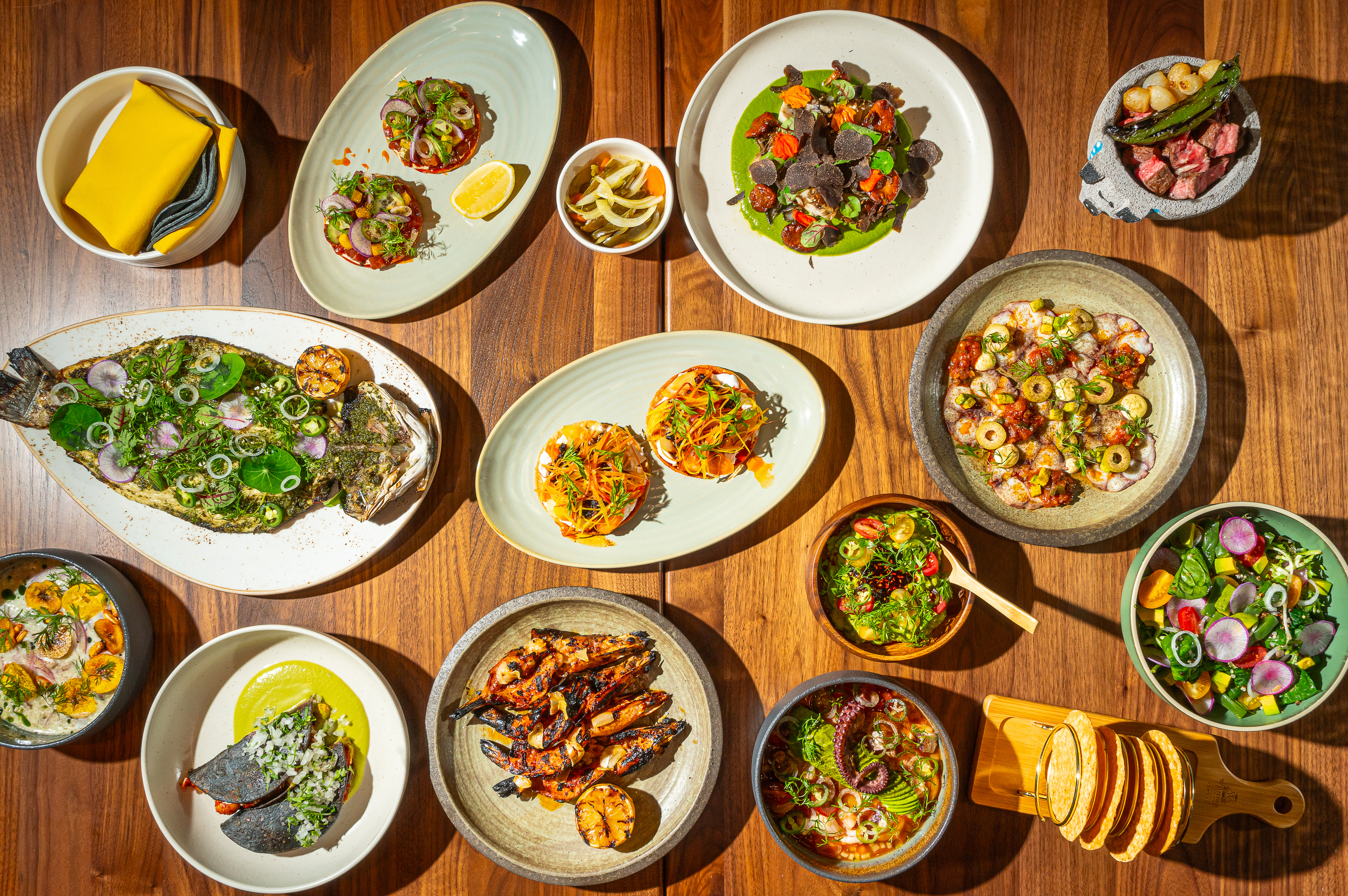 A table fill of ceviche, branzino and other seafood dishes from Nizuc