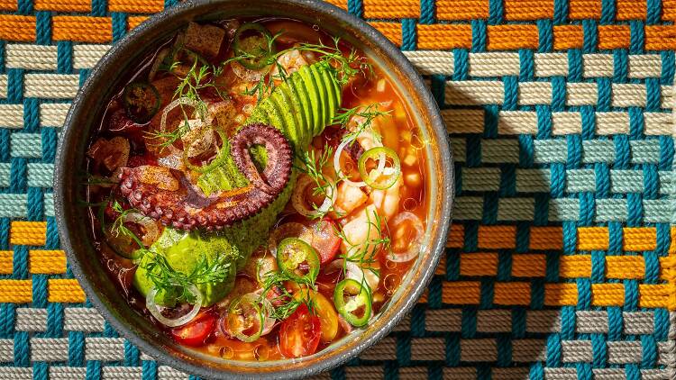 Carpaccio De Pulpo on a orange, white and blue background