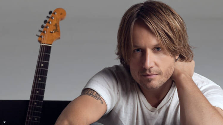 Keith Urban with his guitar behind him