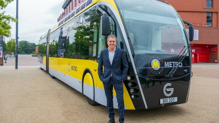 Steve Rotherham, Liverpool's mayor, in front of a yellow bus