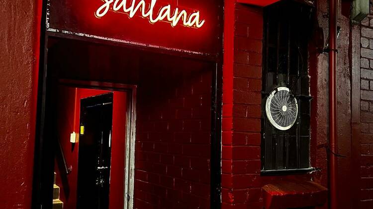 Neon red sign at Santana.