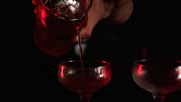 Bartender pouring a cocktail.