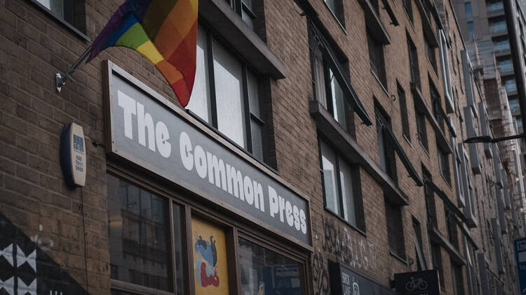 An external shot of The Common Press bookshop, with a rainbow flag flying outside