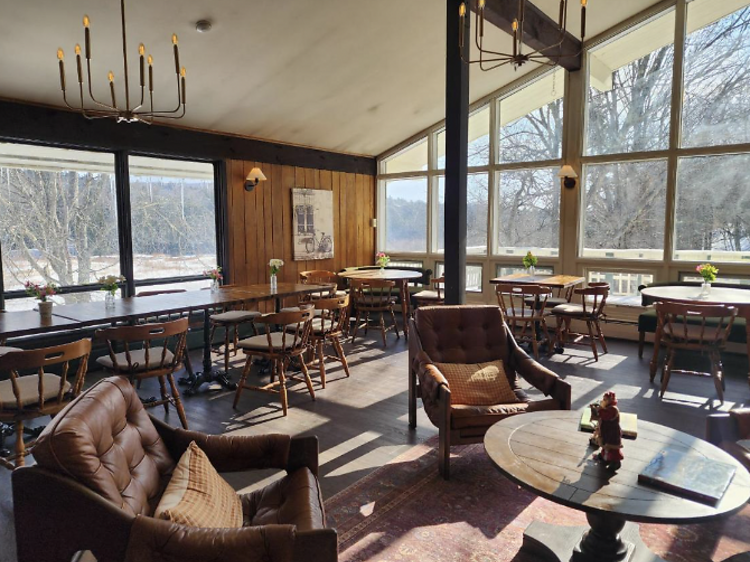 Lounge with wooden flooring and leather chairs