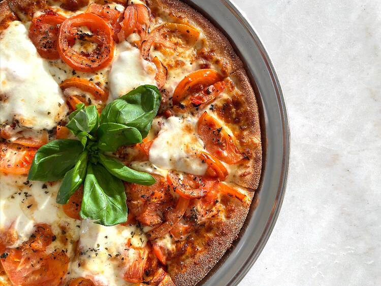 Cheese and tomato pizza with basil