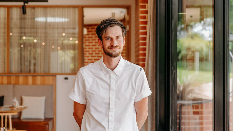 Chef Jack Cassidy standing in the dining space of Kin.