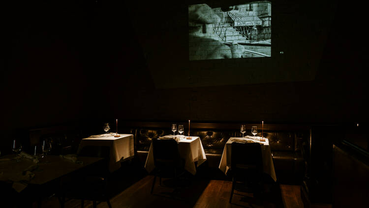 FIlm projector and dimly lit tables at Bianchetto.