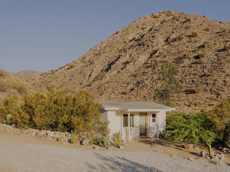 Tiny home nestled in the bushes by a canyon in Morrongo Valley