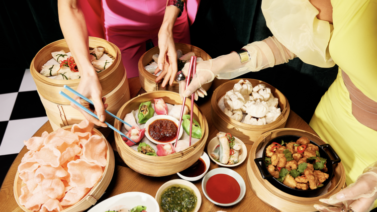 Two women dressed up eating Yum Cha