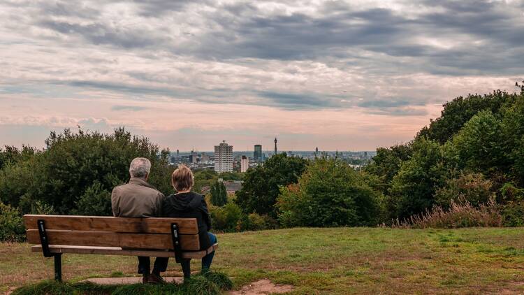 Elderly couple sat on bench on Parliament Hill 