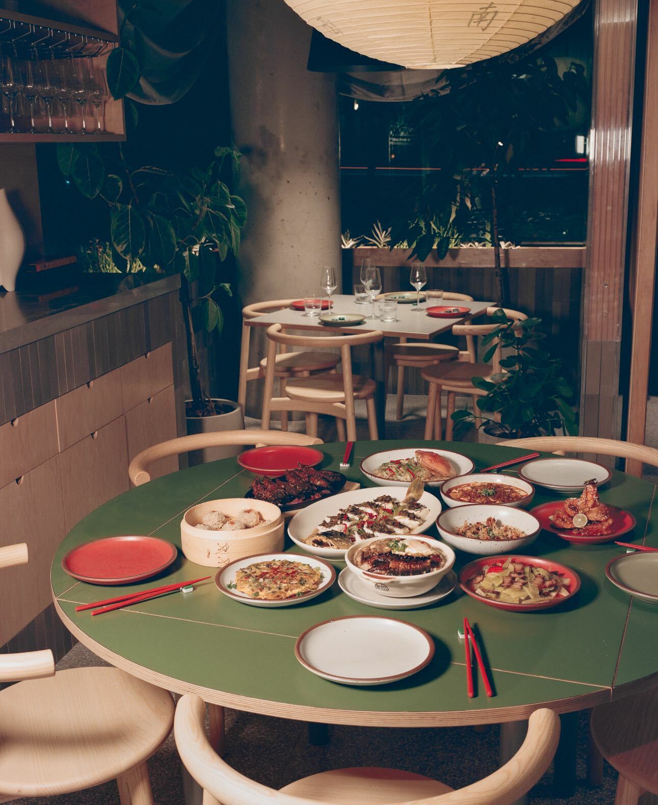 Green table full of Chinese foods