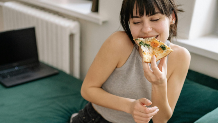 Woman eating pizza