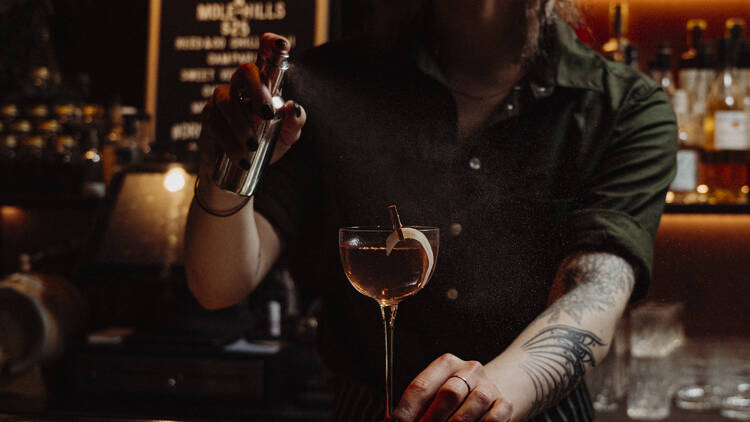 Bartender preparing a cocktail.