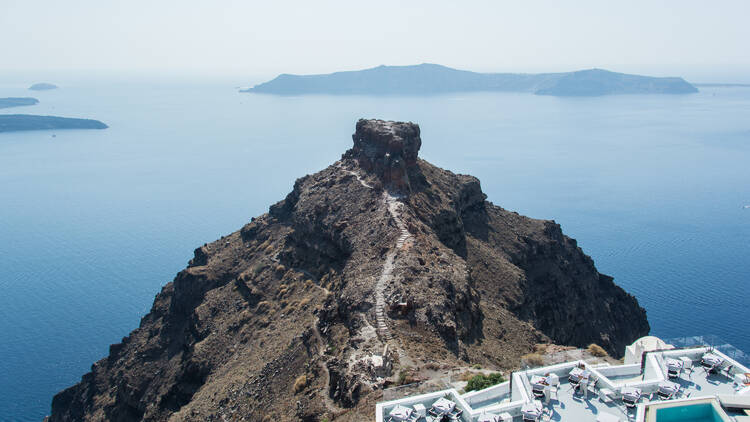 An exterior shot from the bedroom at The Grace Hotel Santorini, looking out over the Calderi volcano and the Aegean Sea