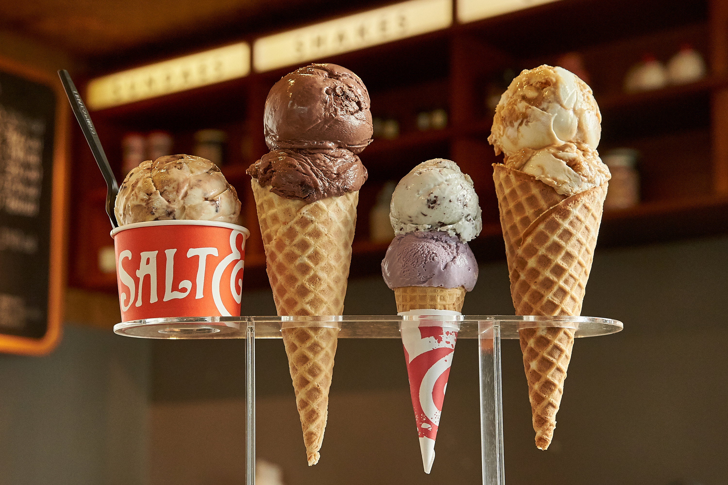 Four ice creams from Salt & Straw, one in a cup the other in cones