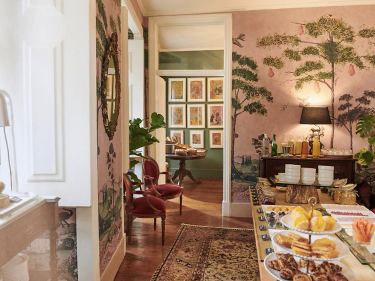 Elegant pink dining room with a breakfast spread.