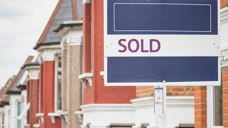 Sold sign on a row of houses 