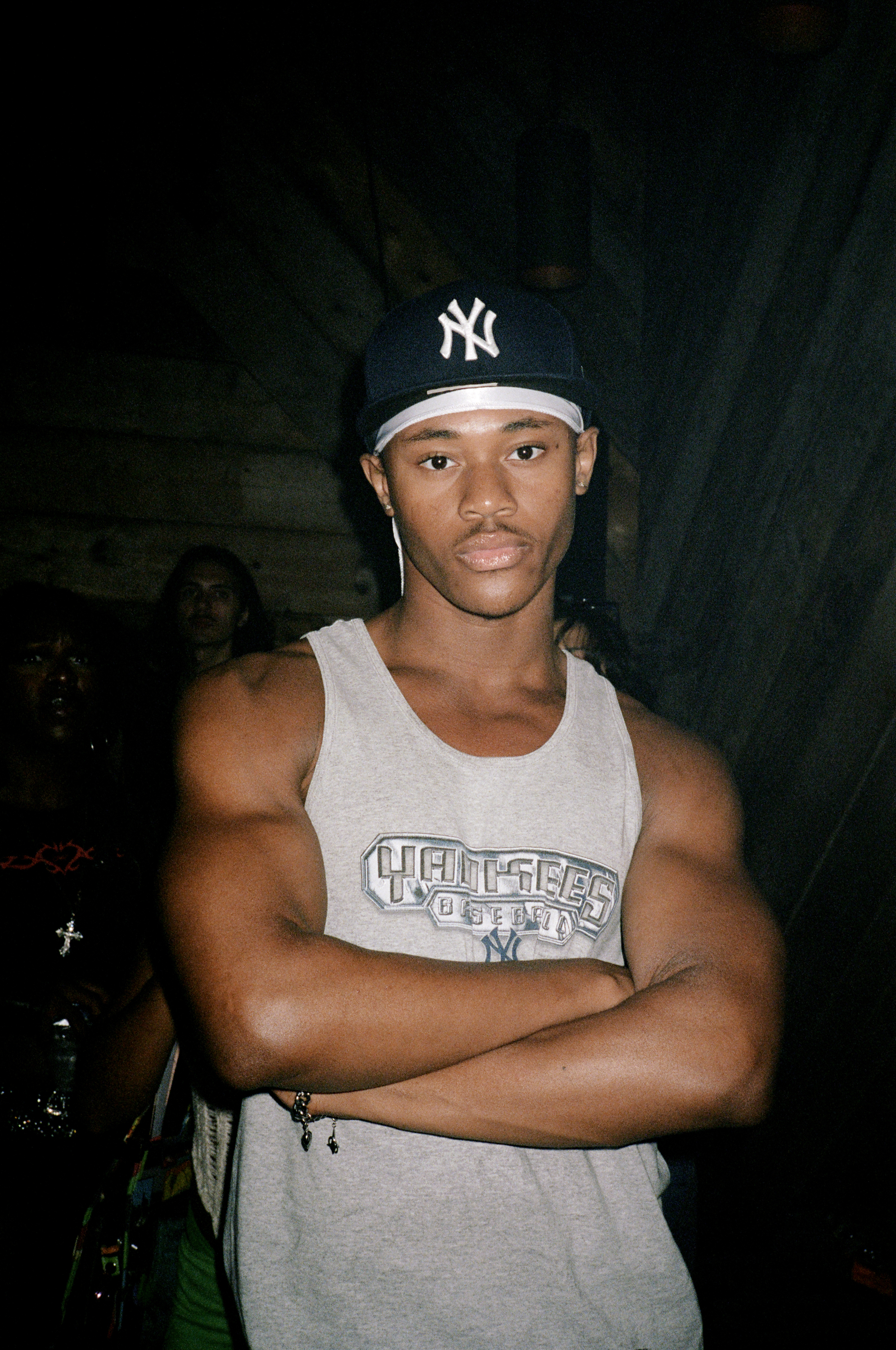 a person in a New York Yankees cap poses at Dick Appointment's 5 Year anniversary party