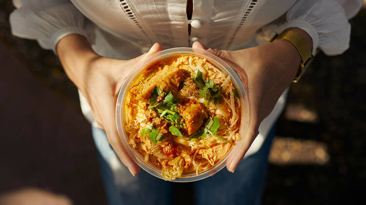 Eat laksa at the Parap Village Markets