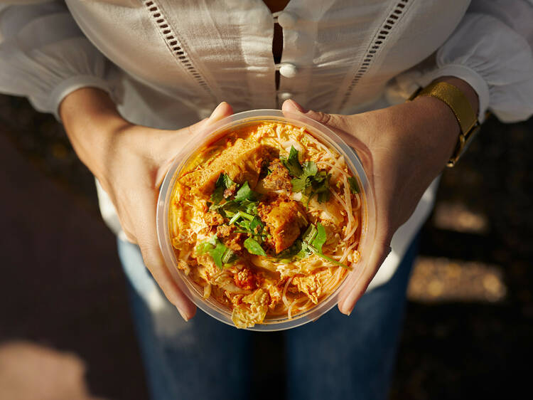 Eat laksa at the Parap Village Markets