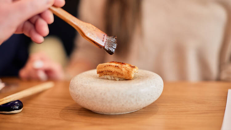 Chef painting sushi.