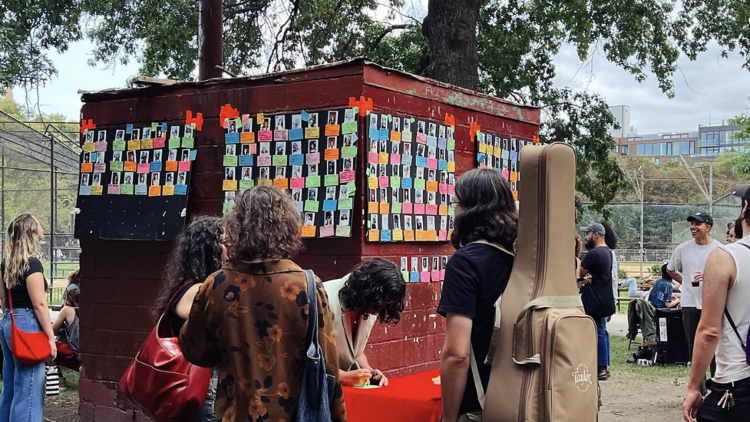 people around a wall with post it notes