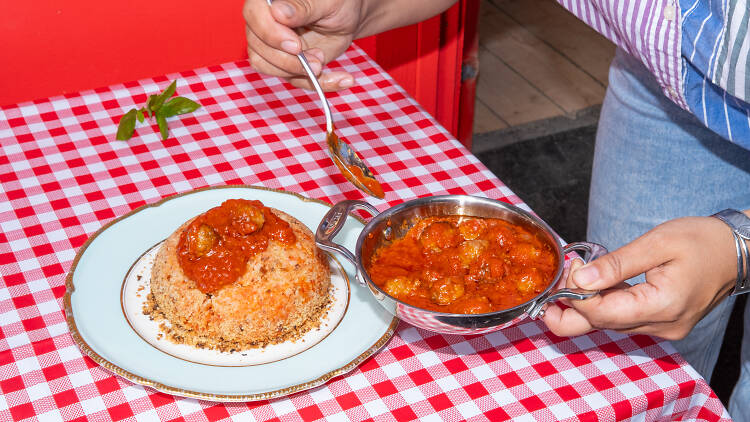 Bomba di Riso dish on a checkered tablecloth