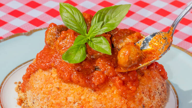 Bomba di Riso, with meatballs spooned on top