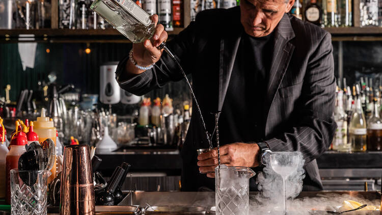 Bartender pouring a cocktail