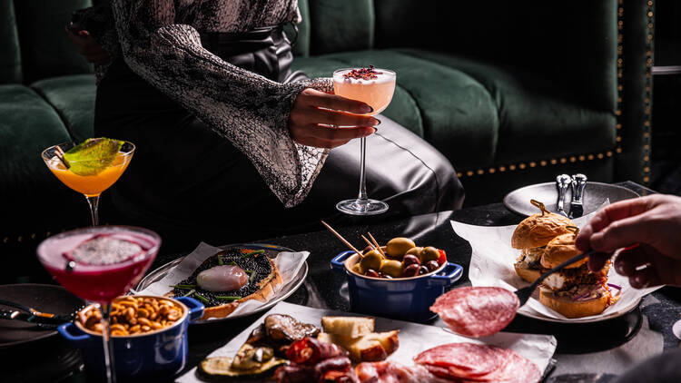 Spread of food and drinks on a bar table