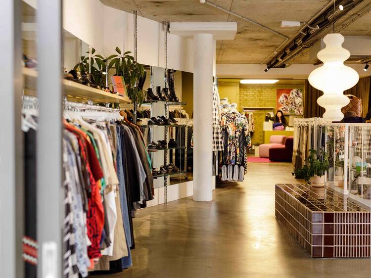 A clothing store filled with racks of clothes. 