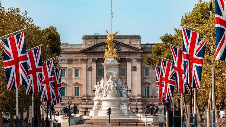 Buckingham Palace in London with Union Jack flags