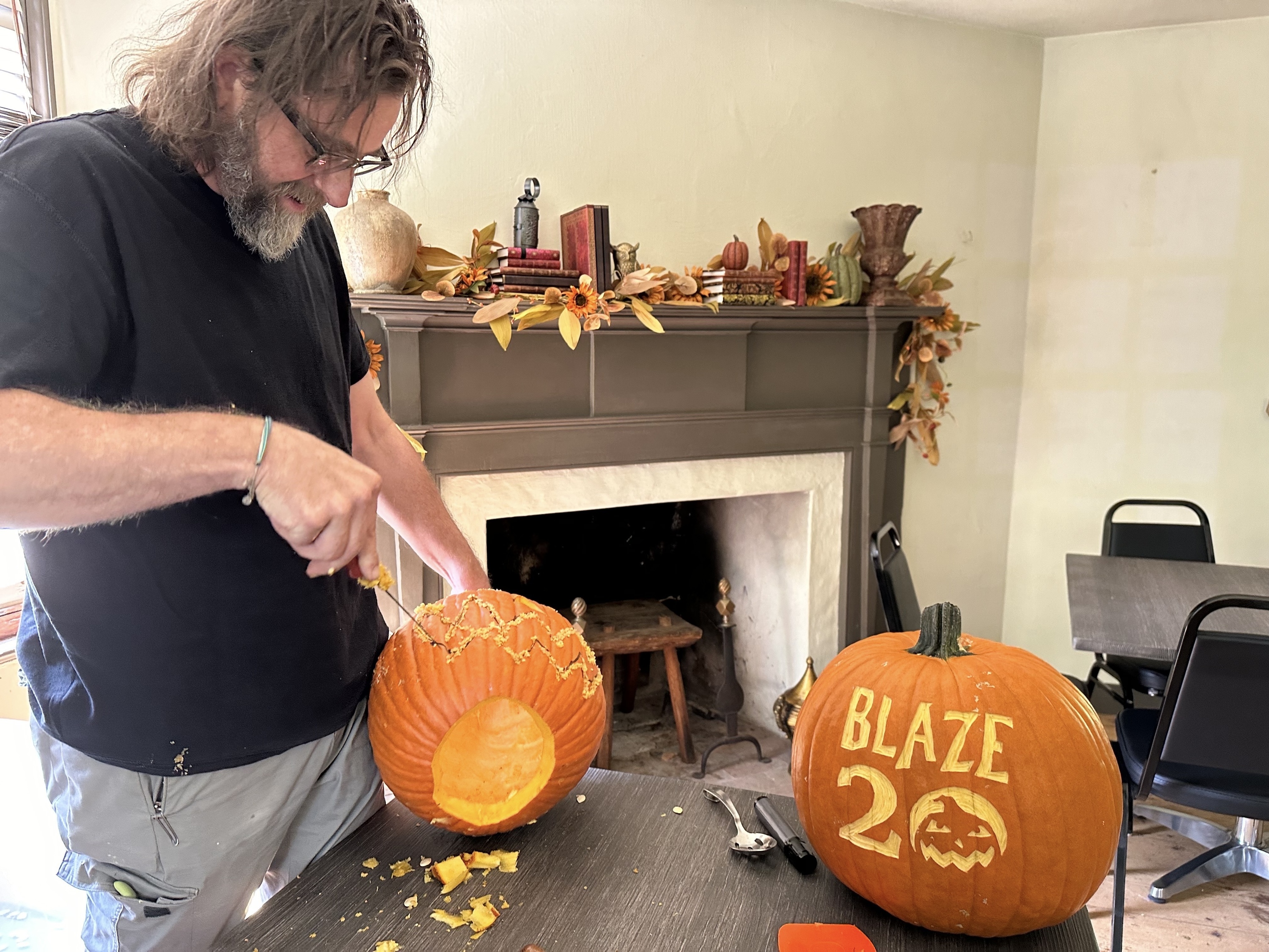 A man carves a pumpkin.