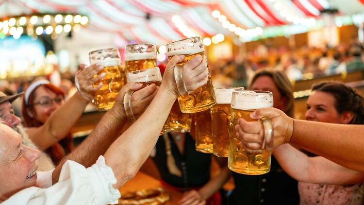 Group of friends drinking steins of beer 