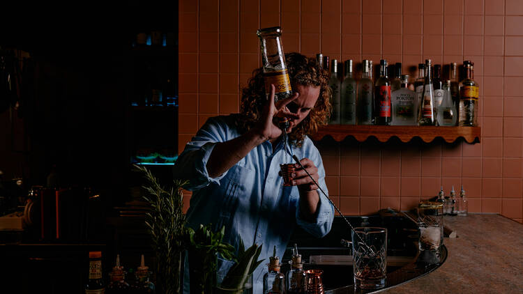 Bartender pouring cocktails.