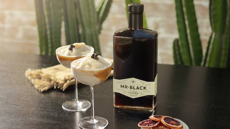 Mr Black liqueur sitting next to two espresso martini cocktails